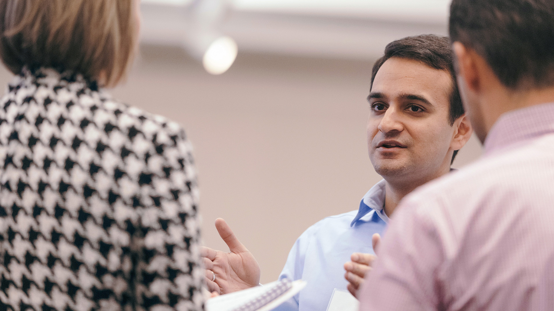 Male Oxy employee speaking to colleagues